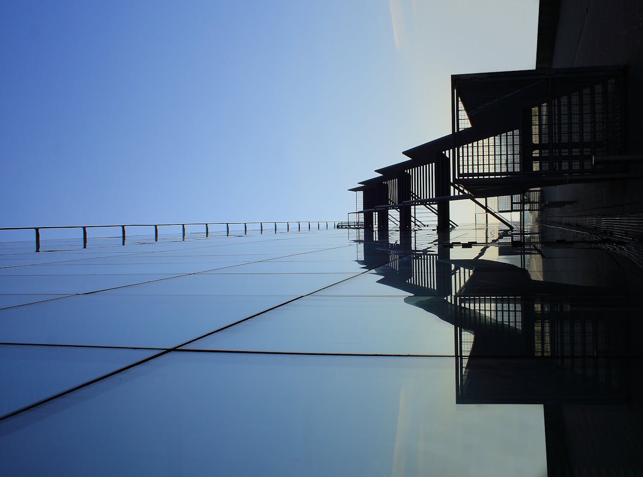 A striking glass skyscraper reflecting blue skies, showcasing modern architecture's elegance.